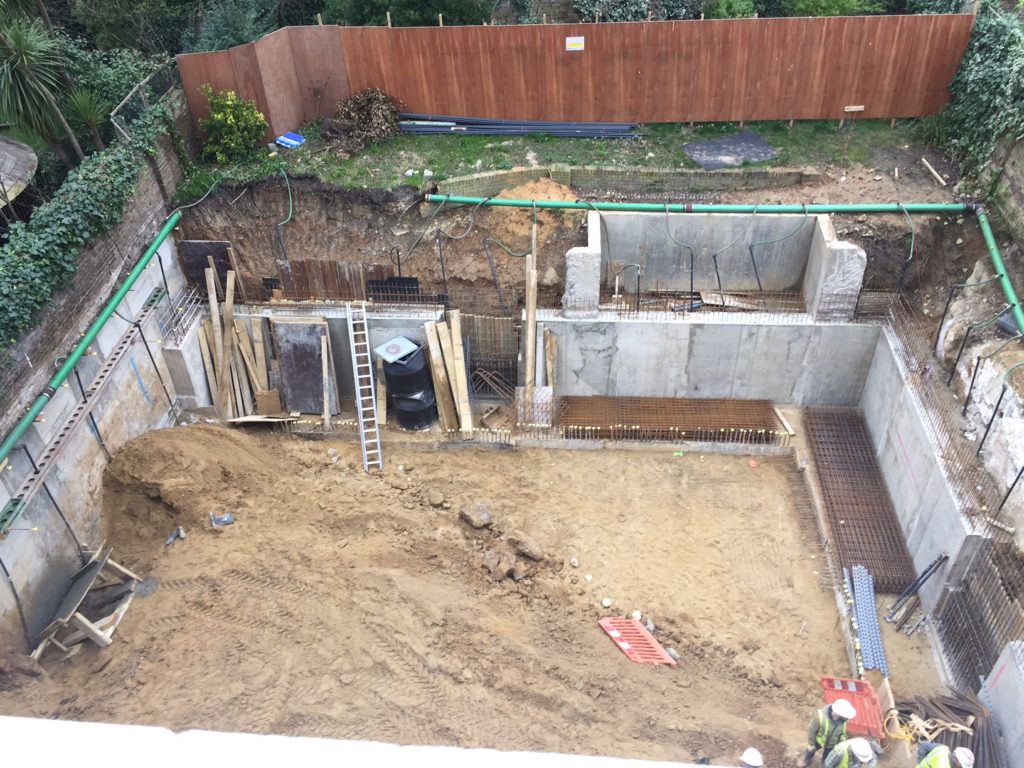 Mid-stage excavation with perimeter retaining walls being formed in sequence as bulk dig progresses at the Holland Villas Road basement project.